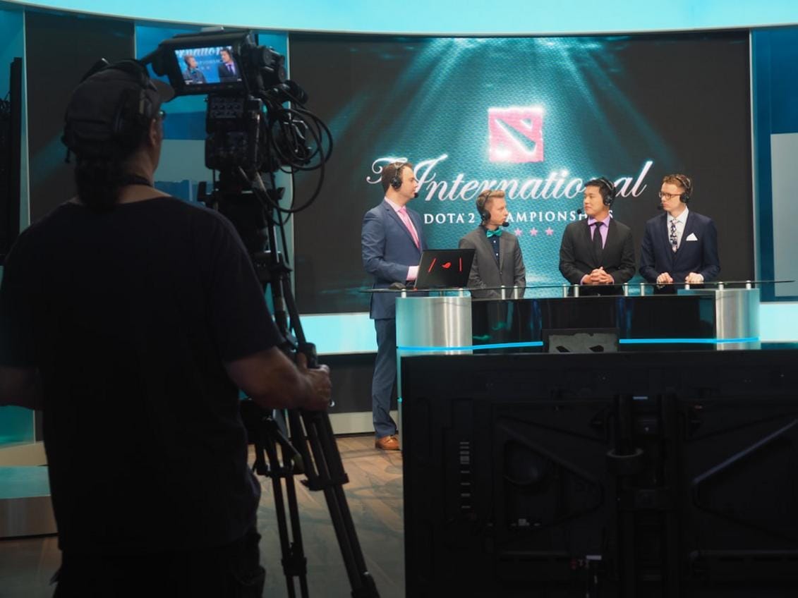 a professional esports player analyzing gameplay footage with a focus on camo and tactics in a modern gaming setup