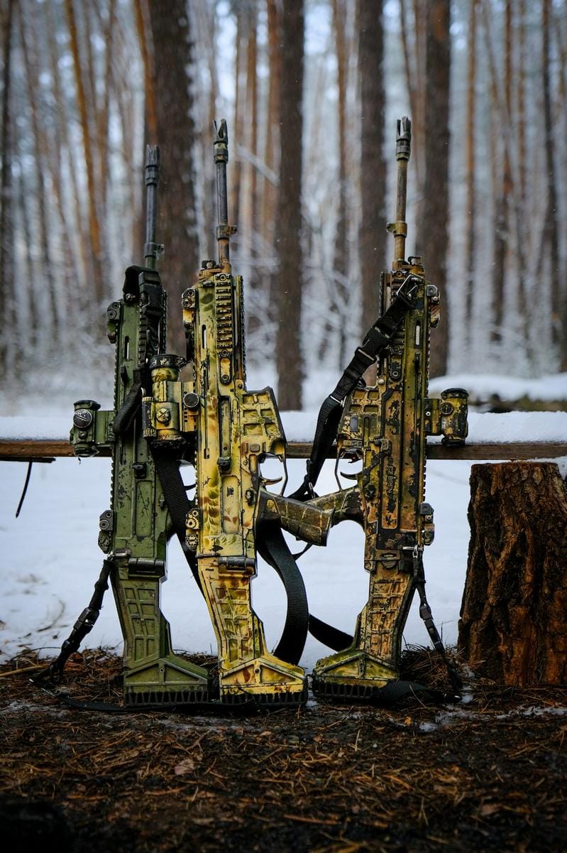 a player displaying multiple camo options on their weapon in a Call of Duty game