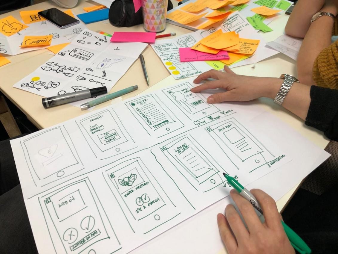 producers, directors, and executives discussing concept art and production design for upcoming Xbox film adaptations, with screens showing game scenes and storyboards